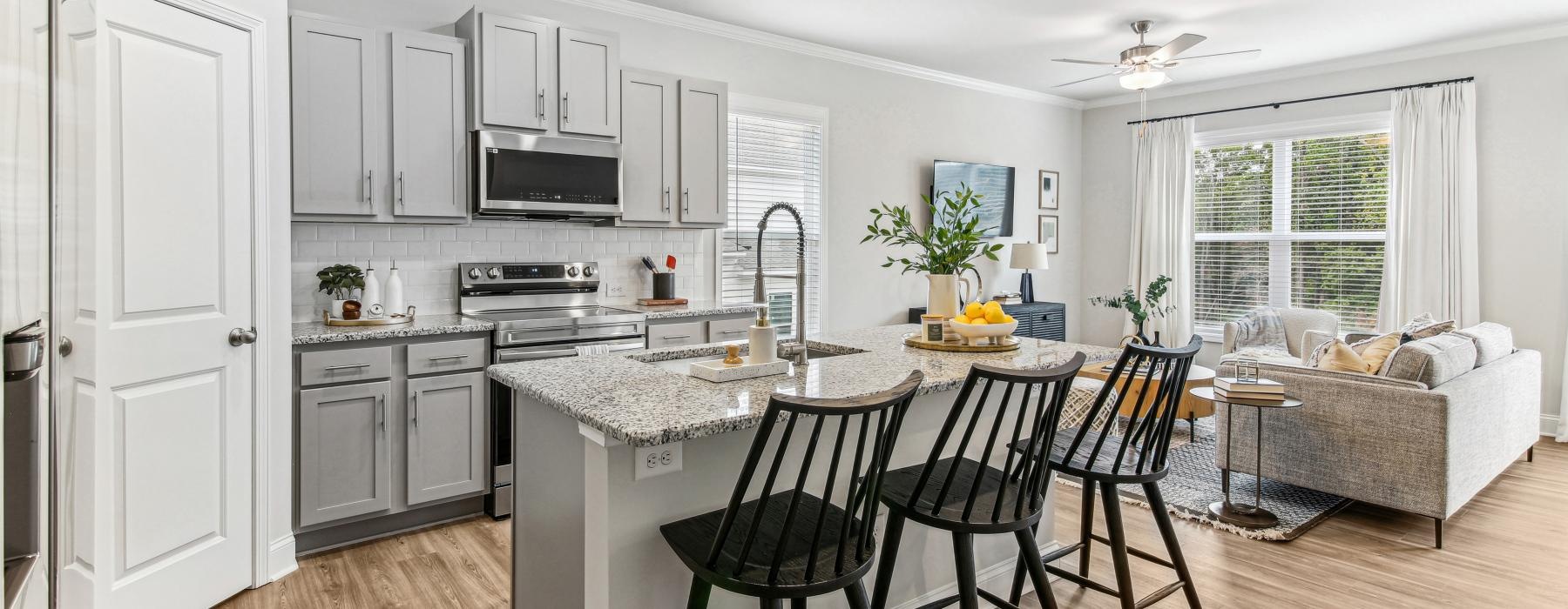 a kitchen with a bar and chairs