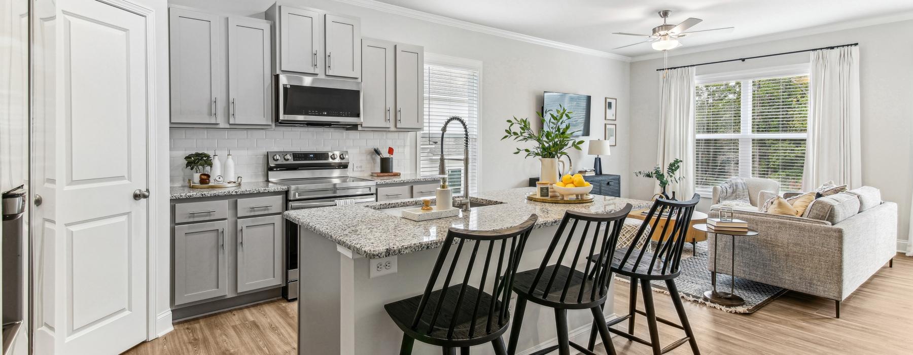 a kitchen with a bar and chairs