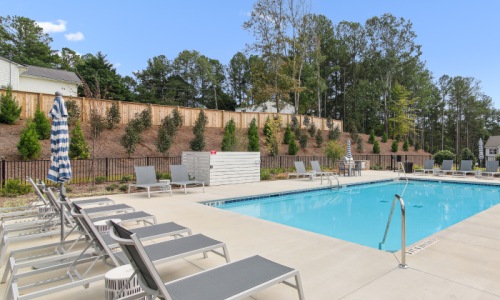 Resort-style swimming pool with lounge seating