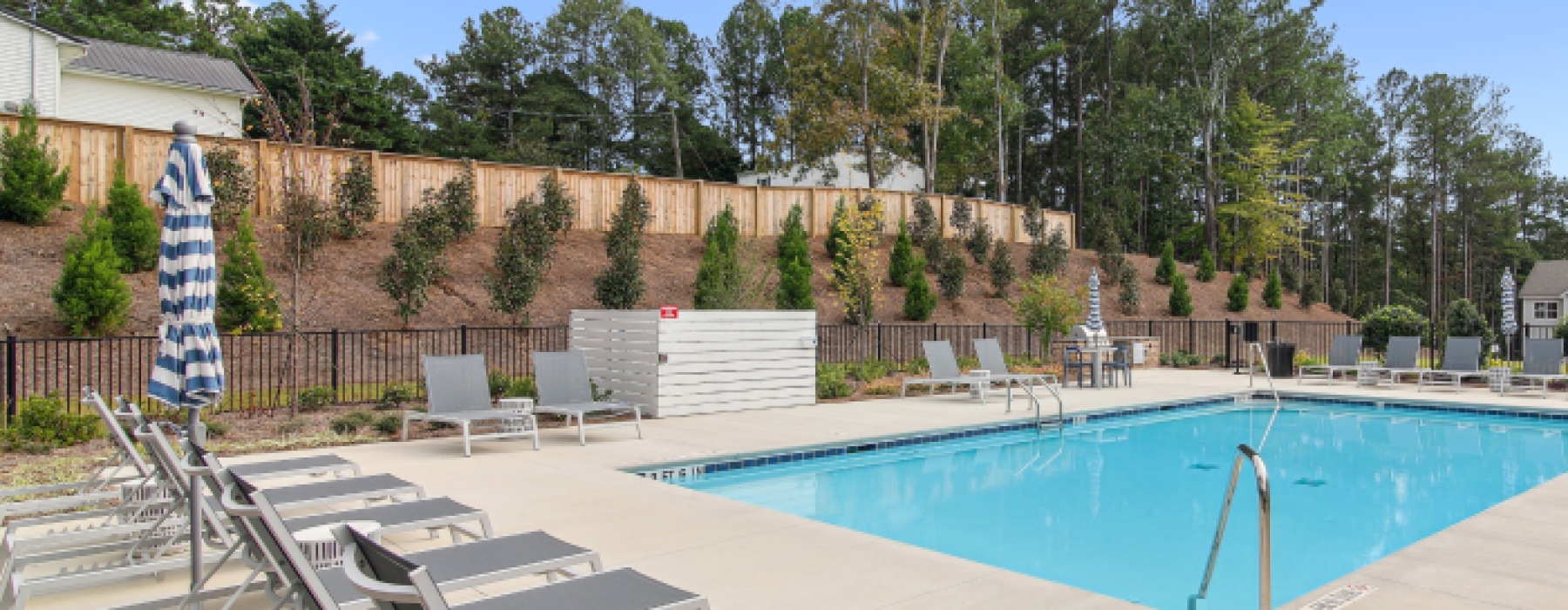 Resort-style swimming pool with lounge seating