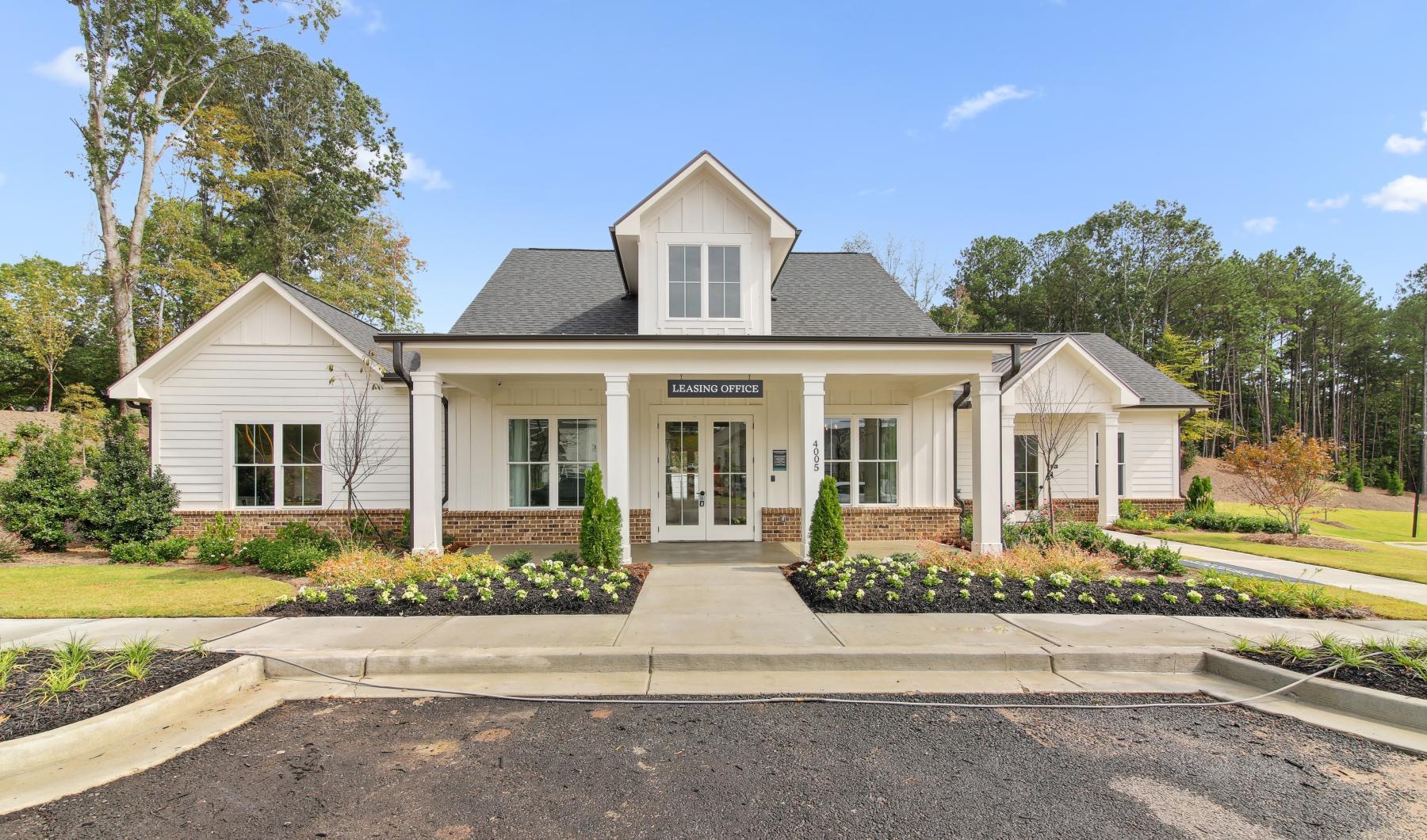 a white building with a driveway